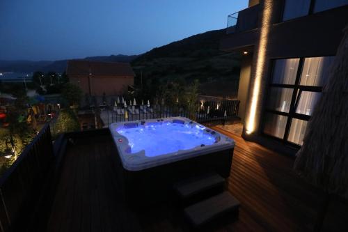 a hot tub sitting on the deck of a building at Toka Hotel Restaurant in Pogradec