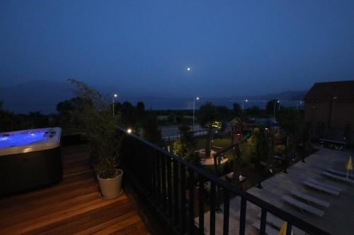 a balcony with a view of the city at night at Toka Hotel Restaurant in Pogradec