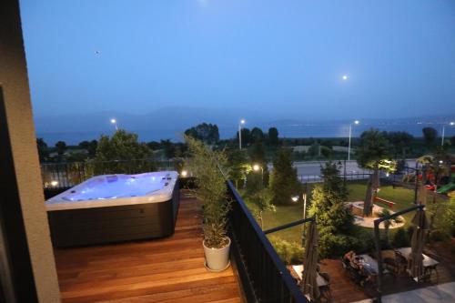 a hot tub on the deck of a balcony at Toka Hotel Restaurant in Pogradec