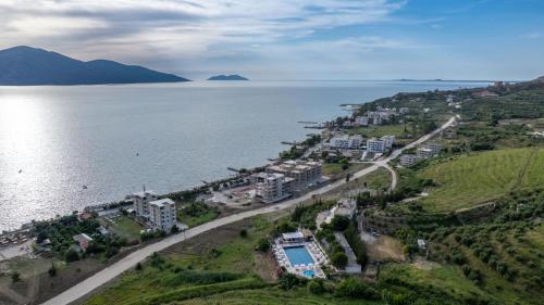 an aerial view of a town next to a body of water at Edva Resort in Vlorë