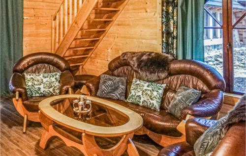 a living room with leather furniture and a table at Pet Friendly Home In Ustka With Wifi in Ustka