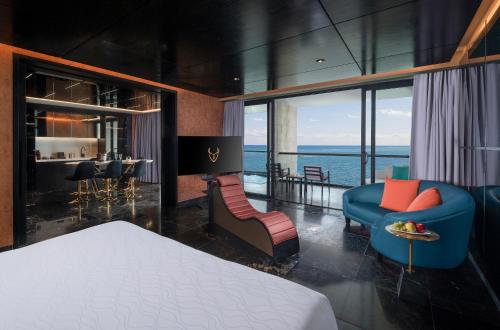a bedroom with a bed and a living room at The Eden by Desire Riviera Maya All Inclusive - Couples Only in Puerto Morelos