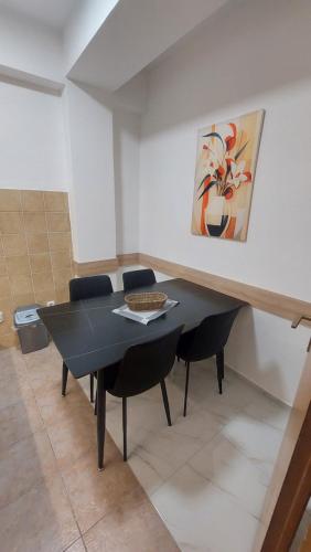 a dining room with a black table and chairs at Petreski Apartments 1 in Ohrid