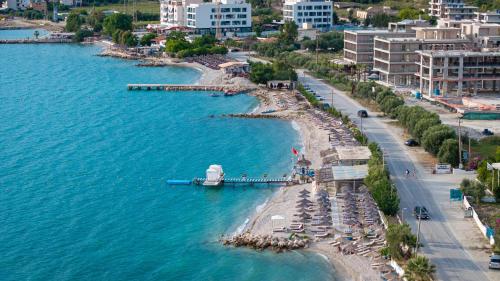 an aerial view of a beach with umbrellas and a boat at Edva Resort in Vlorë