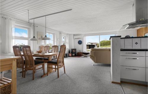 a kitchen and dining room with a table and chairs at 2 Bedroom Cozy Home In Lemvig in Lemvig
