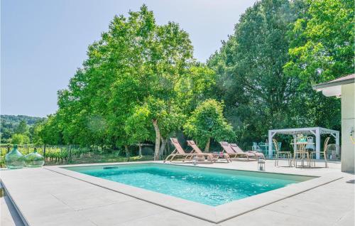 a swimming pool with two chairs and a table at 2 Bedroom Awesome Home In Orte in Orte