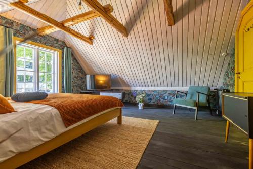 a bedroom with a bed and a desk in a room at Mönus Pesa in Kuressaare