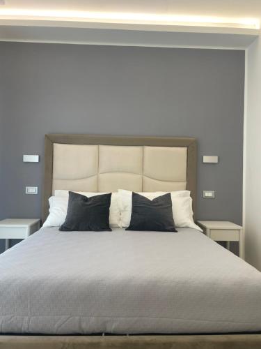 a bedroom with a large bed with black pillows at Wow Rome Home in Rome