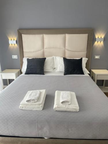 a bed with two towels on top of it at Wow Rome Home in Rome