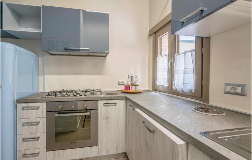a kitchen with a sink and a stove at 2 Bedroom Awesome Home In Orte in Orte