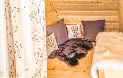 a bed with some pillows and avertisementatronatronstrationbestosbestosbestosbestos at Amazing Home In Ustka With Kitchen in Ustka