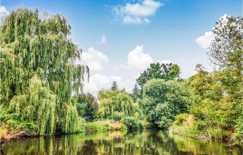 a river in a park with trees and water at Amazing Home In Ustka With Kitchen in Ustka