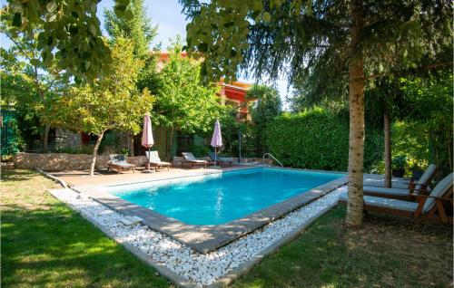 a swimming pool in a yard with a tree at Holiday Home Grubine With Fireplace 10 in Grubine