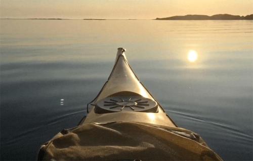 a person in a kayak in the water at sunset at Stunning Home In Farsund With Wifi in Farsund