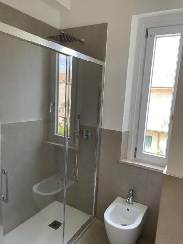 a bathroom with a shower and a toilet and a sink at Sirolo appartamenti in Sirolo
