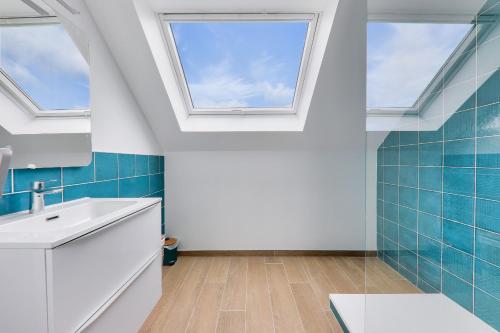 a bathroom with a sink and two skylights at 450m de la plage, grande maison pour 10 in Saint-Philibert