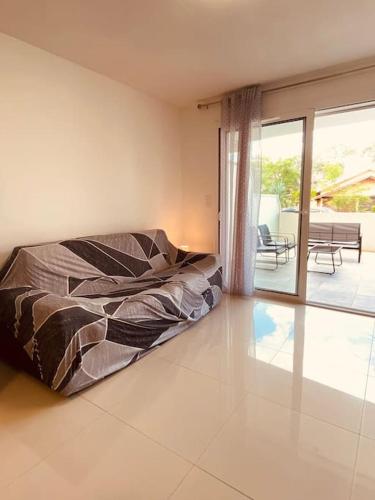 une chambre avec un lit au milieu d'une pièce dans l'établissement Apt climatise avec terrasse et stationnement 100 metres de la plage V0825, à Vias