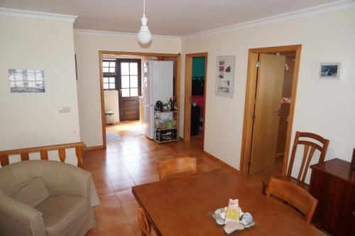 a living room with a table and a couch at Holiday House Tocha in Palheiros da Tocha