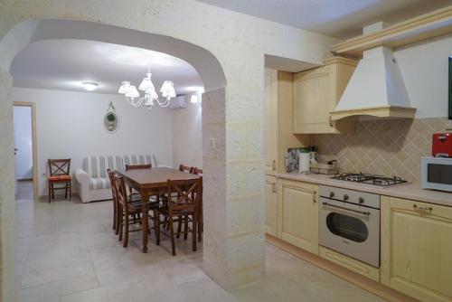 a kitchen with a table and a dining room at Ferienhaus in Zagvozd mit Privatem Pool in Zagvozd