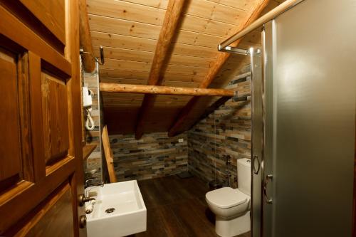 a bathroom with a toilet and a sink at Boutique Hotel Musée in Gjirokastër
