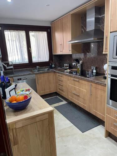 a kitchen with a bowl of fruit on a counter at HAPPY Luxury Apartment - Beachside in Mar Azul, Estepona in Estepona