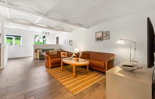 a living room with a couch and a table at Broagerland ferielejlighed Sønderborg Gråsten in Broager