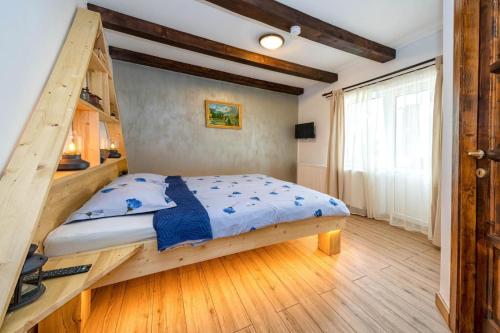 a bedroom with a bunk bed with a ladder at Cabana la Flo in Sohodol