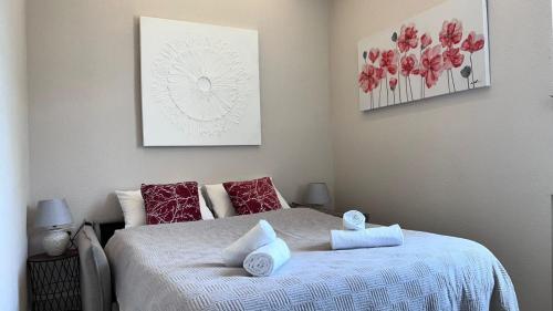 a bedroom with a bed with red and white pillows at Apartment Dora 1 , on the beach in Tivat