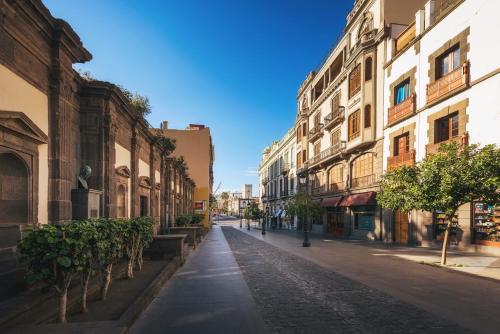 an empty street in a city with buildings at MASANET Emblematic Hotels - Adults Only in Las Palmas de Gran Canaria