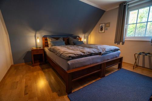 a bedroom with a large bed with a blue ceiling at Jachthuus in Brilon