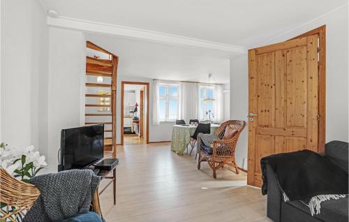 a living room with a couch and a tv at One-Bedroom Holiday Home In Allinge in Allinge