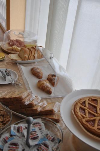 a table topped with plates of food and pies at B&B La Terrazza Degli Scrittori in Racalmuto