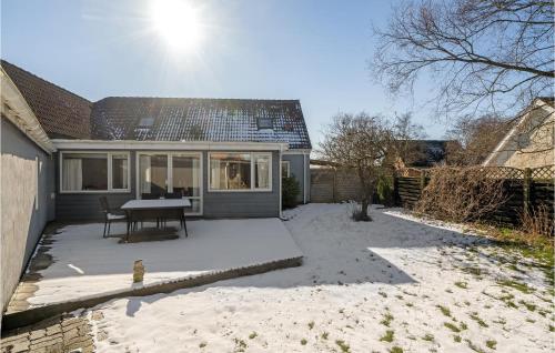 a patio with a table in front of a house at 4 Bedroom Pet Friendly Home In Spøttrup in Spottrup