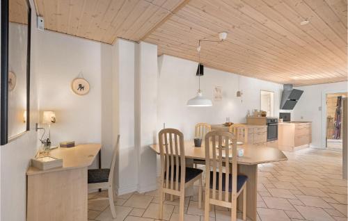 a kitchen and dining room with a table and chairs at 4 Bedroom Pet Friendly Home In Spøttrup in Spottrup