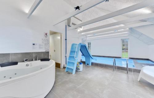 a bathroom with a blue slide and a swimming pool at Lovely Home In Ulfborg With Sauna in Ulfborg