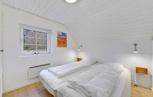 a white bedroom with a bed in a room with a window at Lovely Home In Ulfborg With Sauna in Ulfborg