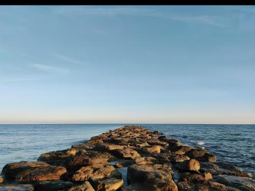 a group of rocks in the ocean at Apartamento Dúplex vacacional in Burriana