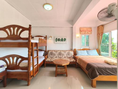 a bedroom with a bunk bed and a bunk ladder at บ้านสุขอรุณ เขาค้อ Baan Sook A Roon KhaoKho in Khao Kho