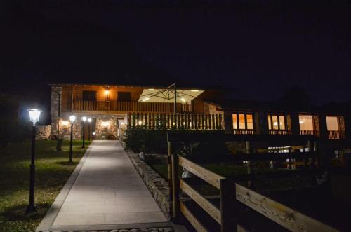 a walkway leading to a house at night at La Caigola in Ala