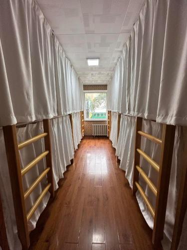 an empty room with white curtains on the walls at Camel Track Guesthouse and Tour Operator LLC in Ulaanbaatar