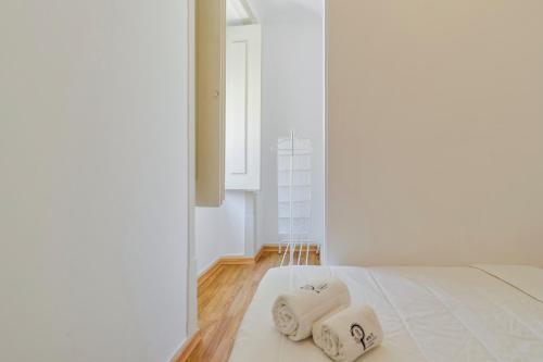 a bedroom with two towels on a bed at Mercy House - BY Y Concept in Setúbal