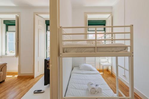 a couple of bunk beds in a room at Mercy House - BY Y Concept in Setúbal