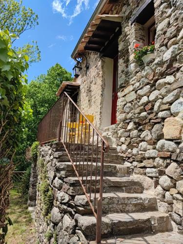 a set of stone stairs leading to a stone house at Le Mas De Ribard in Bréau-et-Salagosse