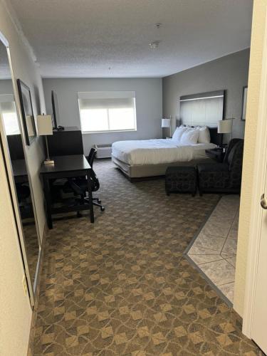 a hotel room with a bed and a desk at Comfort Inn Huntington near University area in Huntington