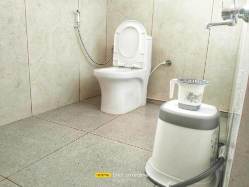 a bathroom with a toilet in a shower stall at Valley Vista Villa Madikeri Coorg in Madikeri
