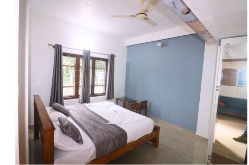 a bedroom with a bed and a window at Valley Vista Villa Madikeri Coorg in Madikeri