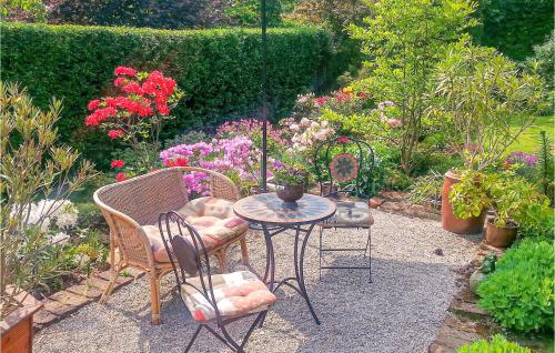 a patio with a table and chairs and flowers at Gorgeous Apartment In Sobótka With Wifi in Sobótka
