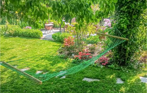 a garden with a hammock in the grass at Gorgeous Apartment In Sobótka With Wifi in Sobótka