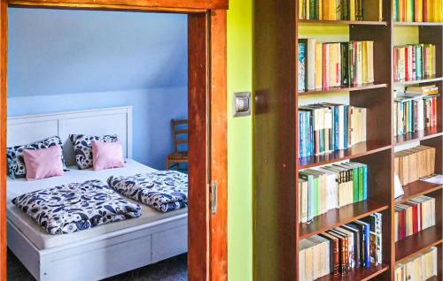 a bedroom with a bed and a book shelf with books at Gorgeous Apartment In Sobótka With Wifi in Sobótka