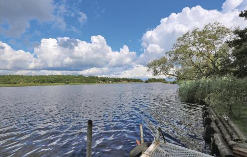 a boat is docked on a large lake at 3 Bedroom Gorgeous Home In Yngsjö in Yngsjö